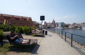 People relaxing on a waterfront in Gdansk